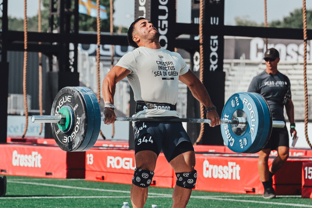 Invictus Athlete making aggressive barbell contact during a snatch at the CrossFit Games.